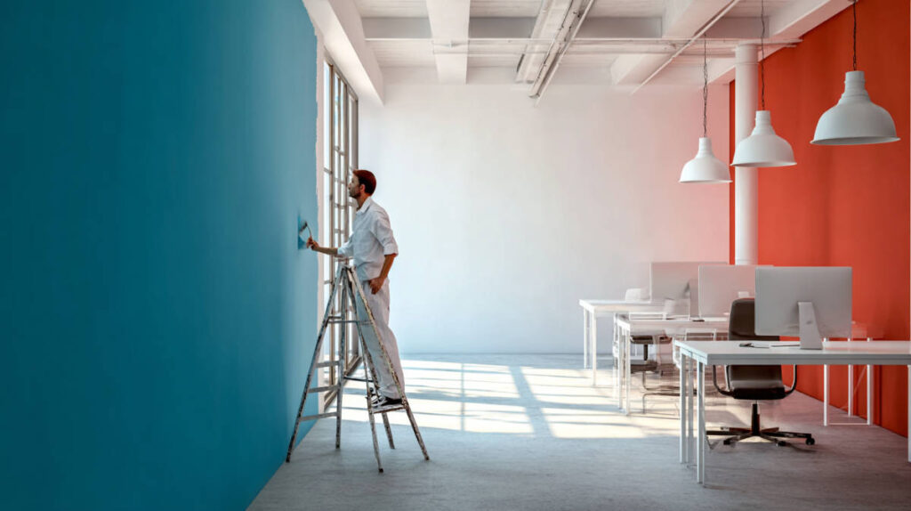 painters in a commercial office space painting a wall