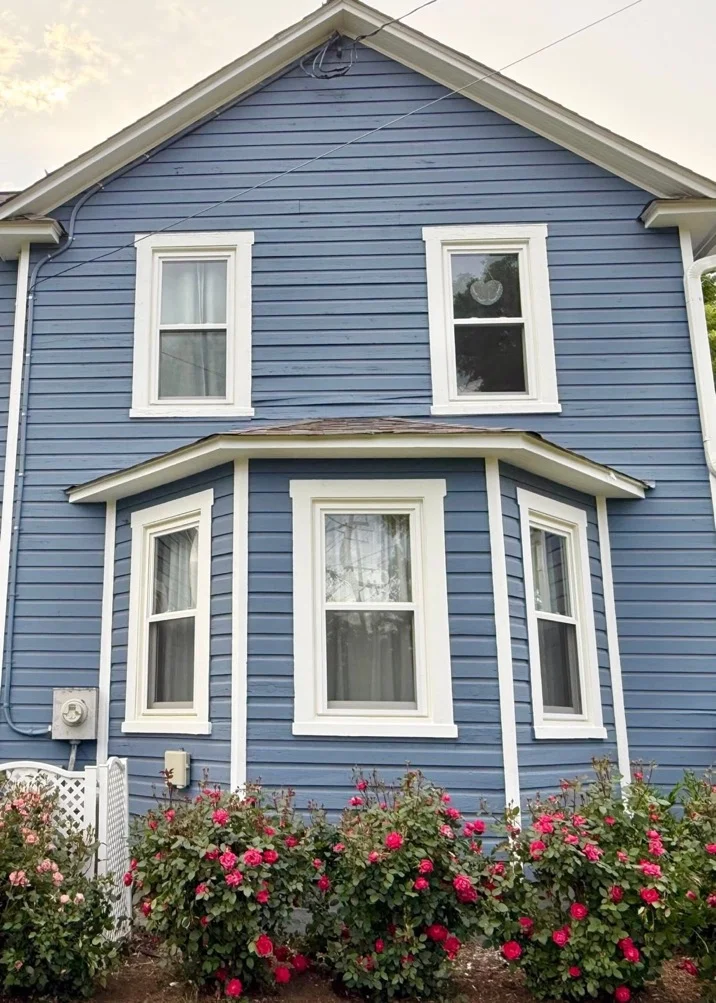 Refreshed side of a home with blue exterior paint